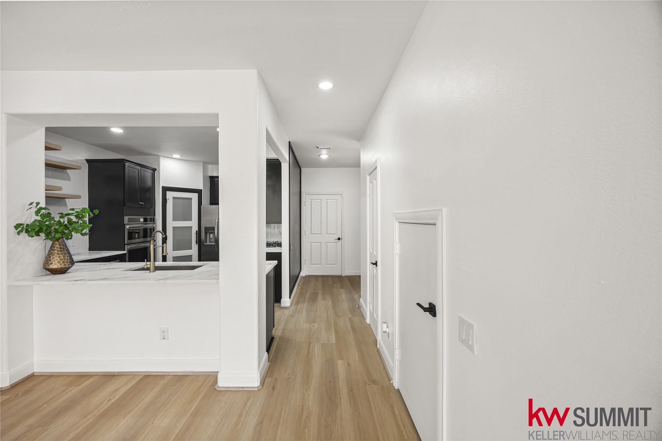 2410 Calumet Street, Unit B Houston, TX 77004 - Photo 12 of 34 a view of a hallway with wooden floor and a bathroom
