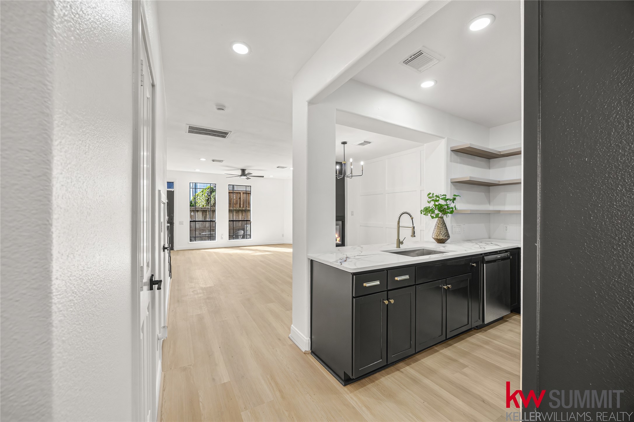 2410 Calumet Street, Unit B Houston, TX 77004 - Photo 6 of 34 a spacious bathroom with a granite countertop sink and a mirror