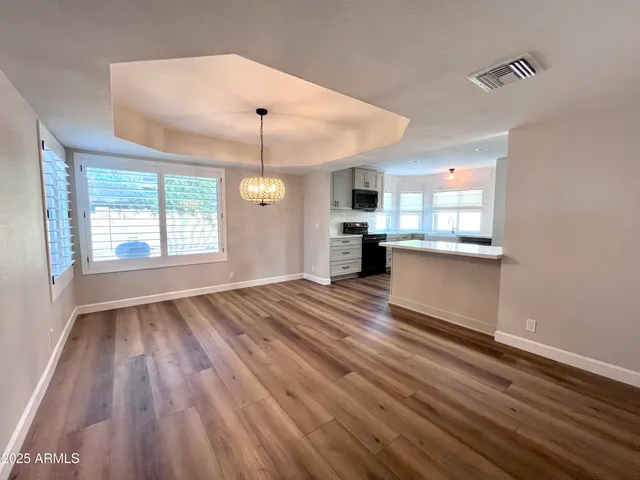 a view of kitchen and hall with wooden floor