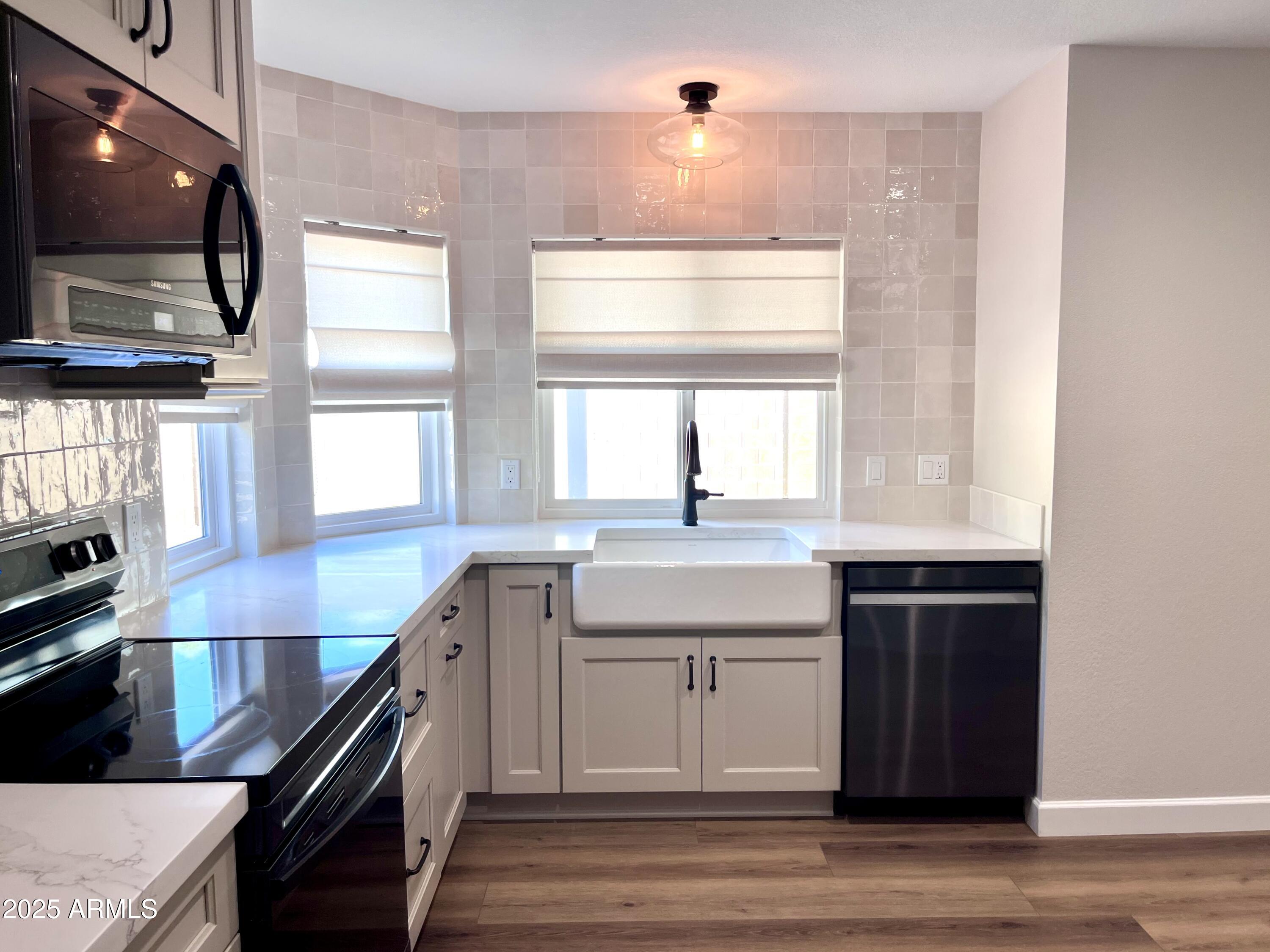 4924 East Hillery Drive Scottsdale, AZ 85254 - Photo 15 of 24 a kitchen with stainless steel appliances granite countertop a sink and a stove