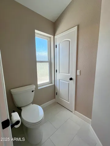 a bathroom with a toilet a sink and shower