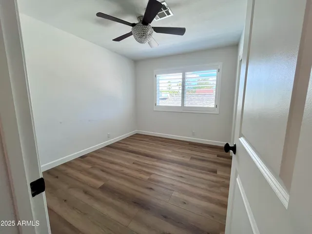 wooden floor in an empty room with a window