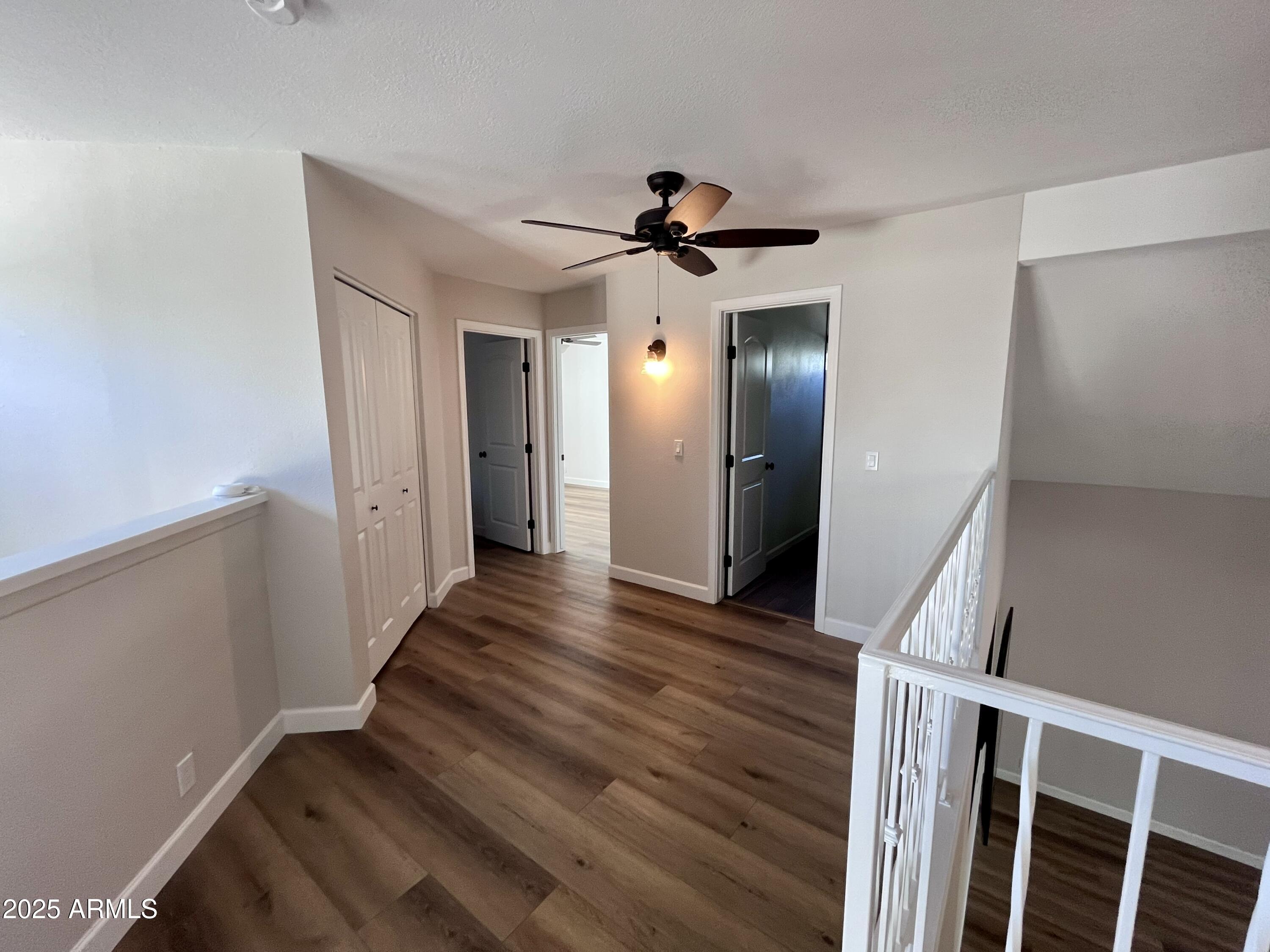 4924 East Hillery Drive Scottsdale, AZ 85254 - Photo 19 of 24 a view of a hallway with wooden floor and staircase