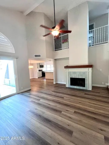 a view of empty room with wooden floor and fireplace