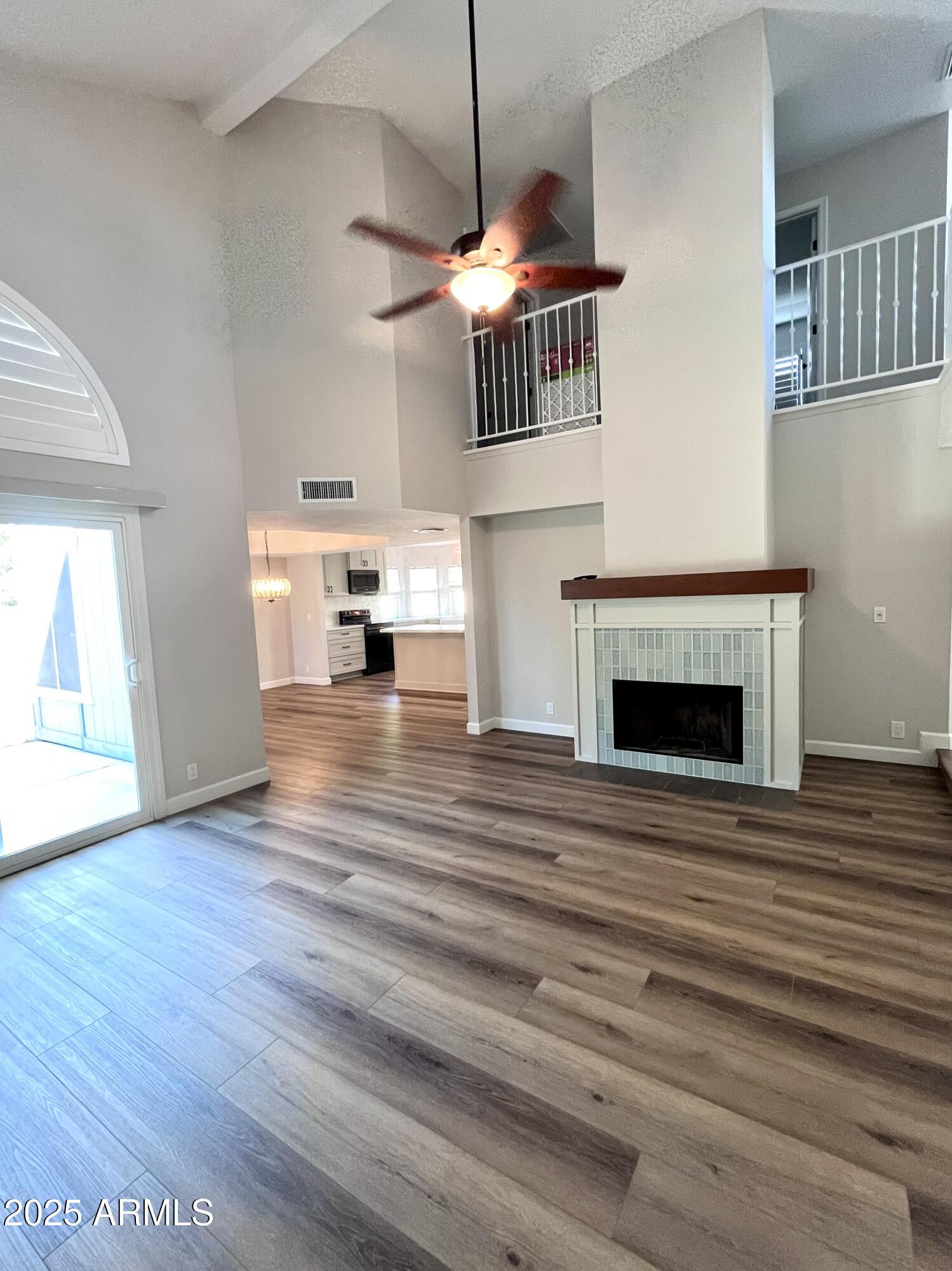 4924 East Hillery Drive Scottsdale, AZ 85254 - Photo 23 of 24 a view of empty room with wooden floor and fireplace