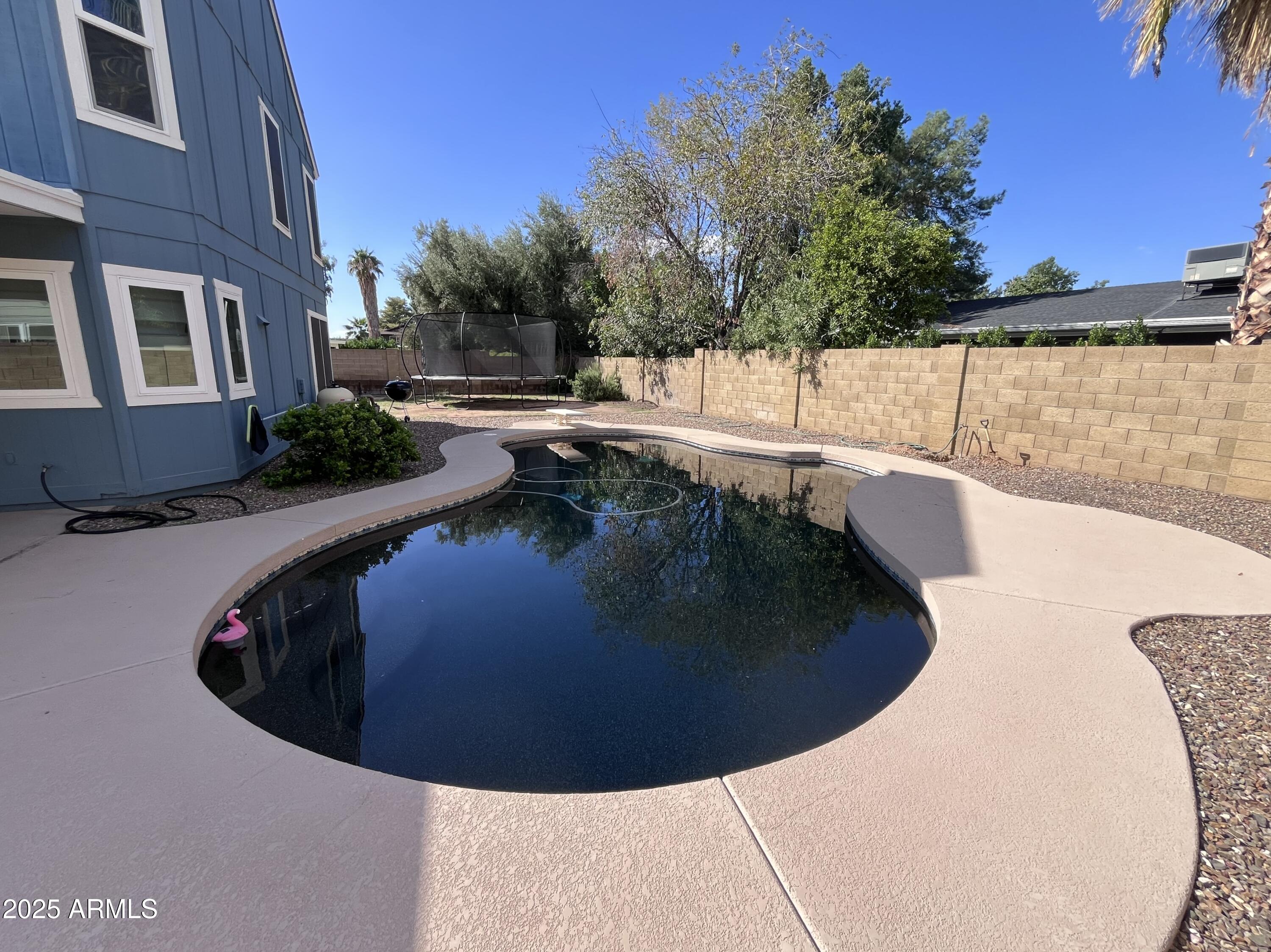 4924 East Hillery Drive Scottsdale, AZ 85254 - Photo 4 of 24 a view of a swimming pool with a house in the background