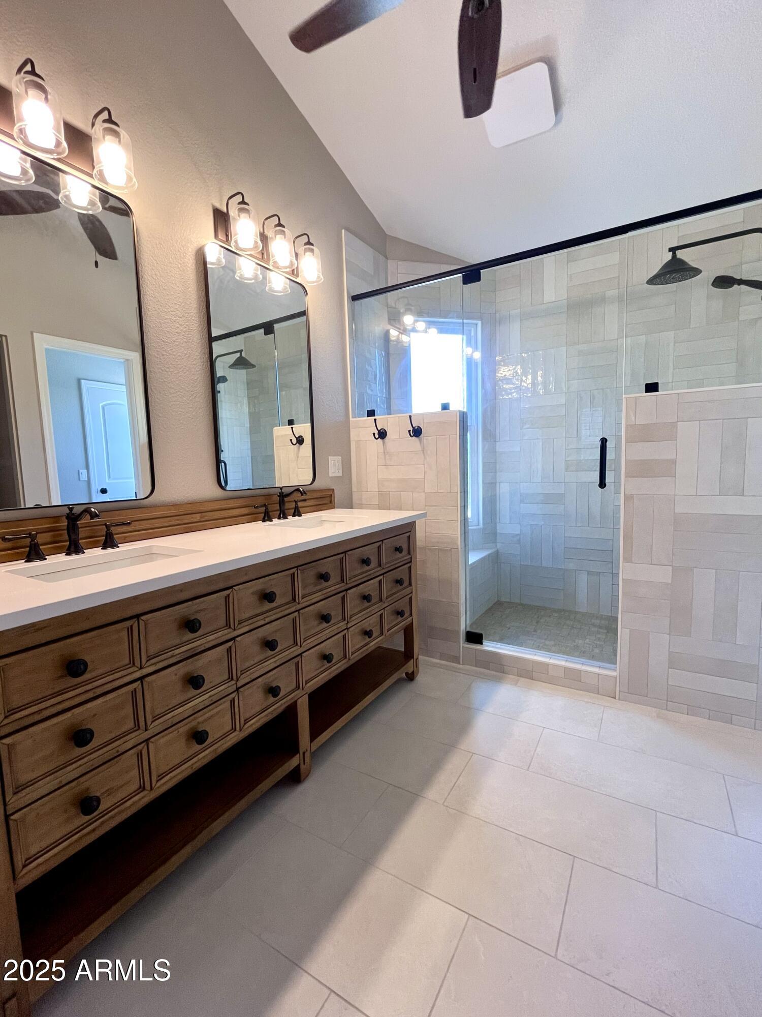 4924 East Hillery Drive Scottsdale, AZ 85254 - Photo 5 of 24 a bathroom with a double vanity sink a toilet a mirror and shower