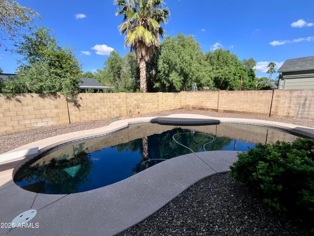 a view of a swimming pool with a patio