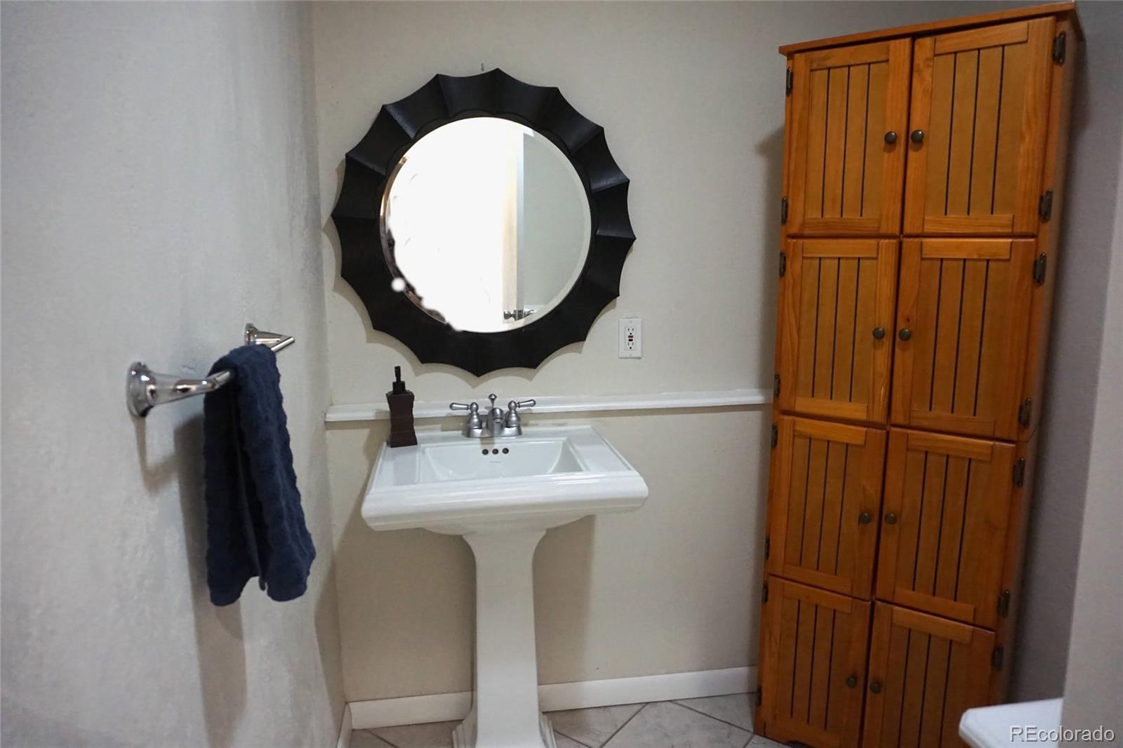 919 Park Street Trinidad, CO 81082 - Photo 16 of 47 a bathroom with a sink and mirror