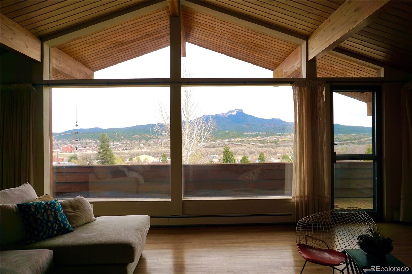 919 Park Street Trinidad, CO 81082 - Photo 22 of 47 a living room with hardwood floor and large windows
