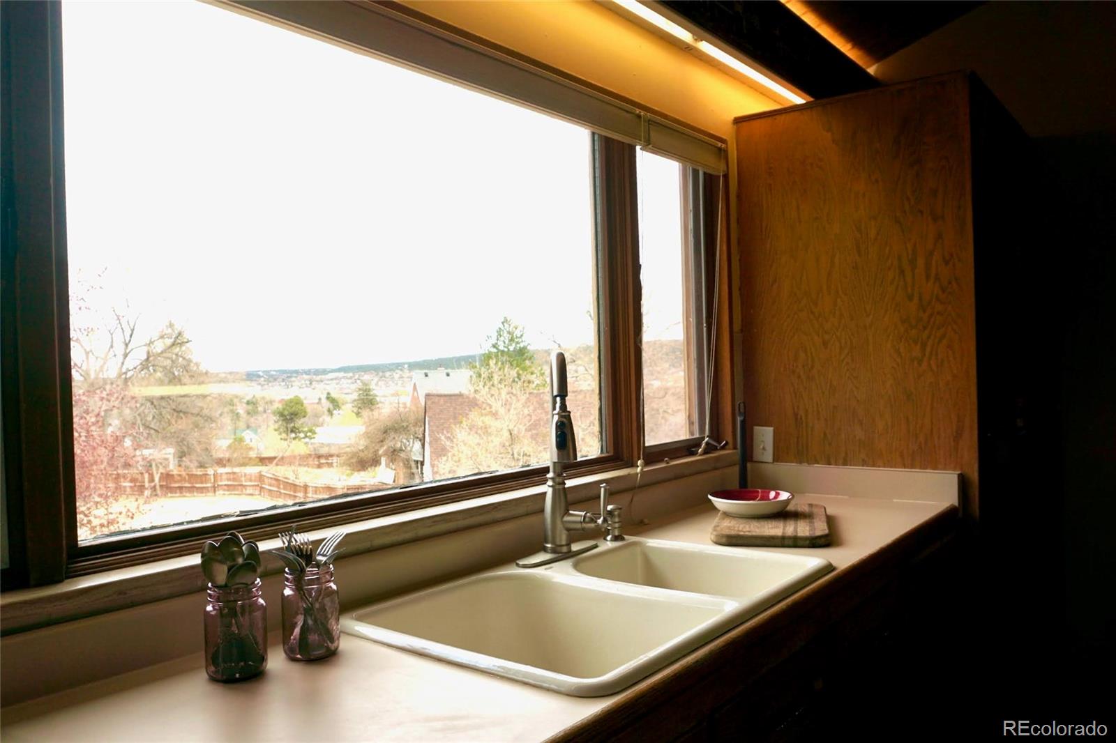 919 Park Street Trinidad, CO 81082 - Photo 29 of 47 a bathroom with a double vanity sink and a large mirror