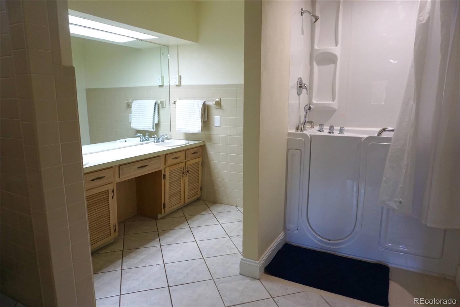 919 Park Street Trinidad, CO 81082 - Photo 38 of 47 a bathroom with a mirror a sink and a shower