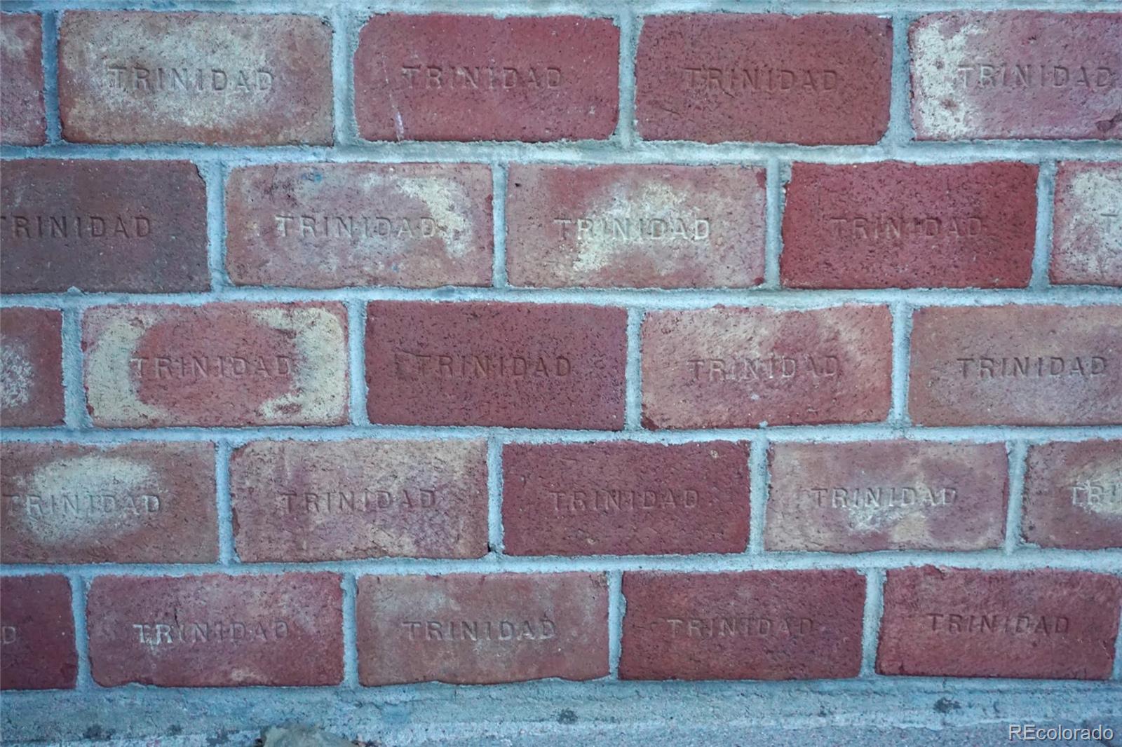 919 Park Street Trinidad, CO 81082 - Photo 47 of 47 a red brick building with glass windows and a yard