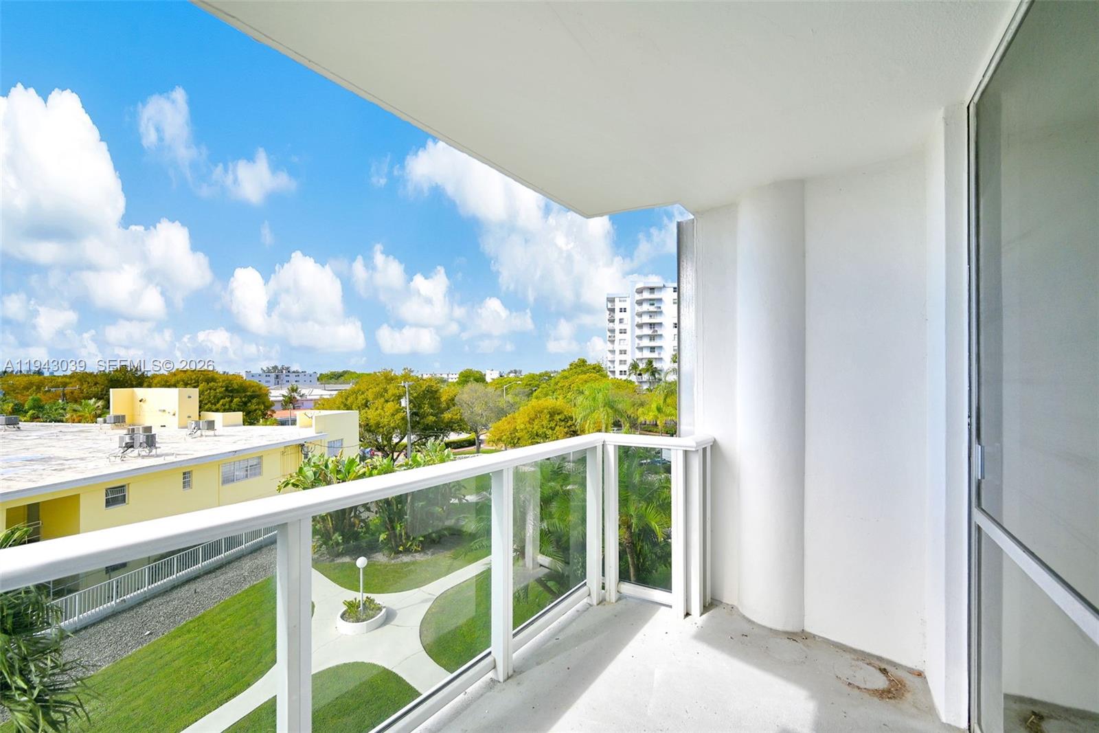 900 Bay Drive, Unit 321 Miami Beach, FL 33141 - Photo 2 of 67 a view of a balcony with wooden floor & fence