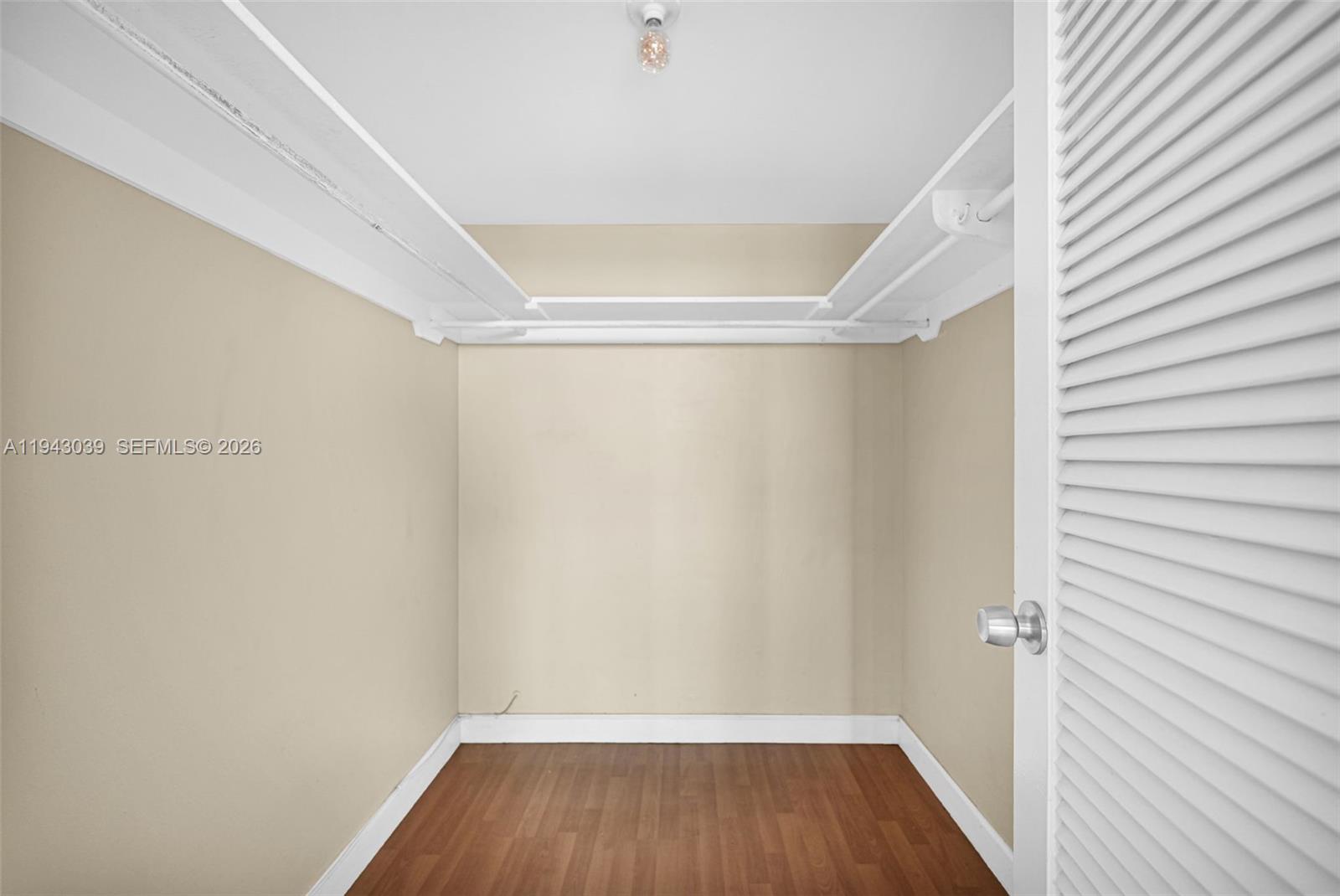 900 Bay Drive, Unit 321 Miami Beach, FL 33141 - Photo 27 of 67 a view of a room with wooden floor and small window