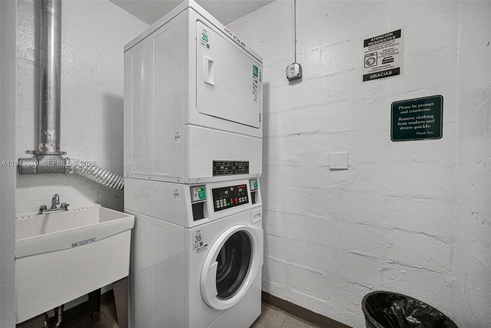 900 Bay Drive, Unit 321 Miami Beach, FL 33141 - Photo 37 of 67 a bathroom with a sink and a washer dryer