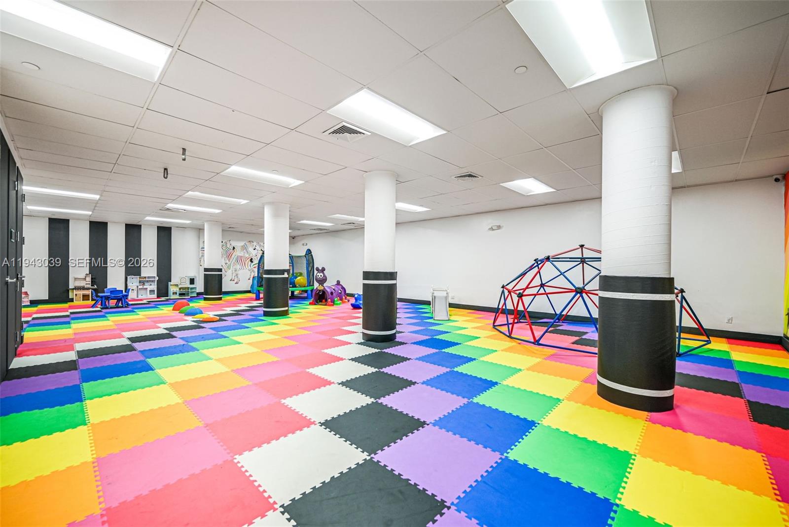 900 Bay Drive, Unit 321 Miami Beach, FL 33141 - Photo 40 of 67 a room with lots of white furniture and wooden floor