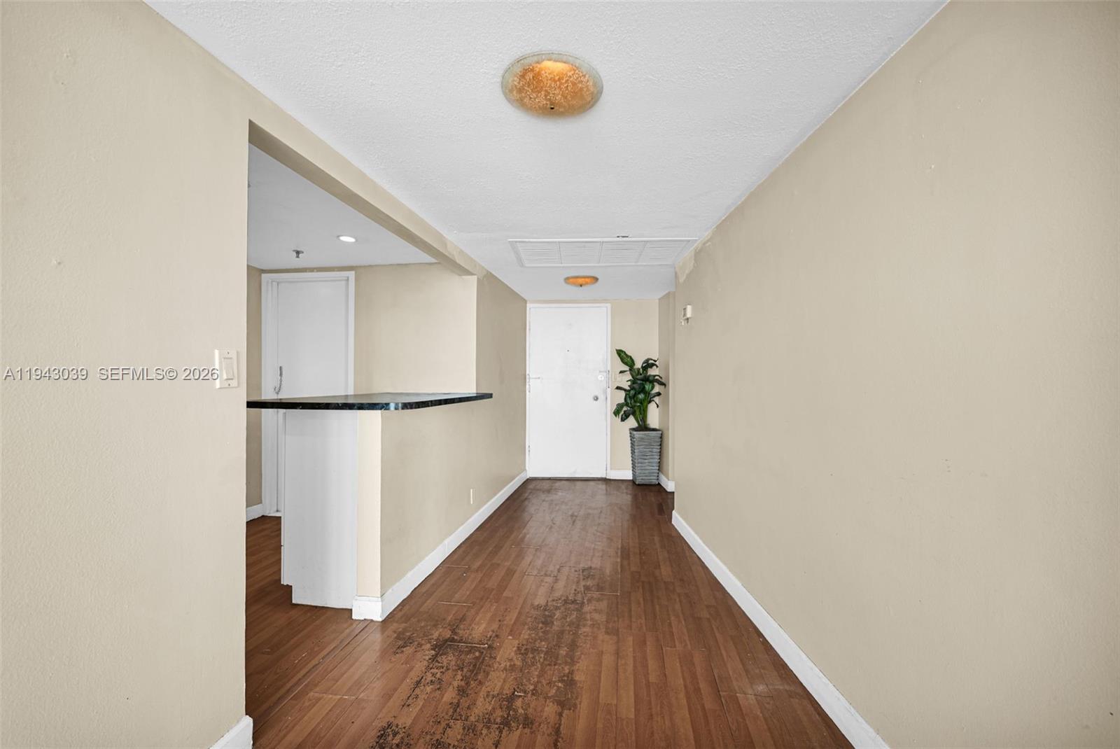 900 Bay Drive, Unit 321 Miami Beach, FL 33141 - Photo 4 of 67 a view of a hallway with wooden floor