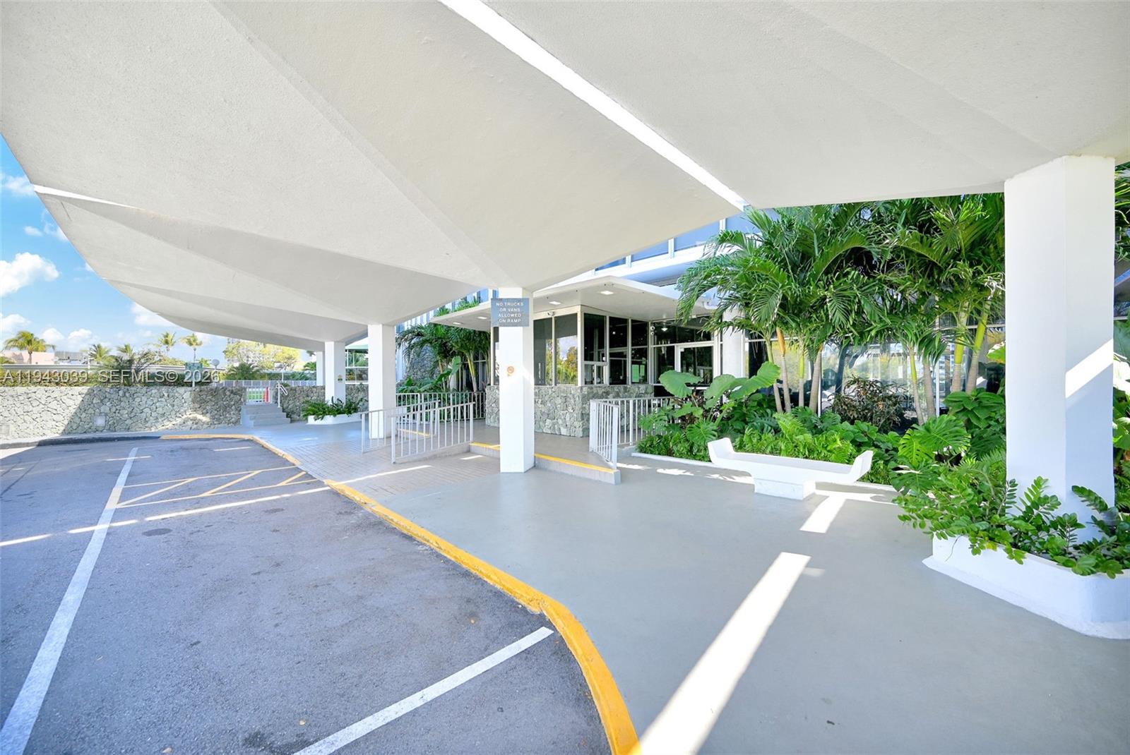 900 Bay Drive, Unit 321 Miami Beach, FL 33141 - Photo 58 of 67 a view of a patio with a table and chairs under an umbrella