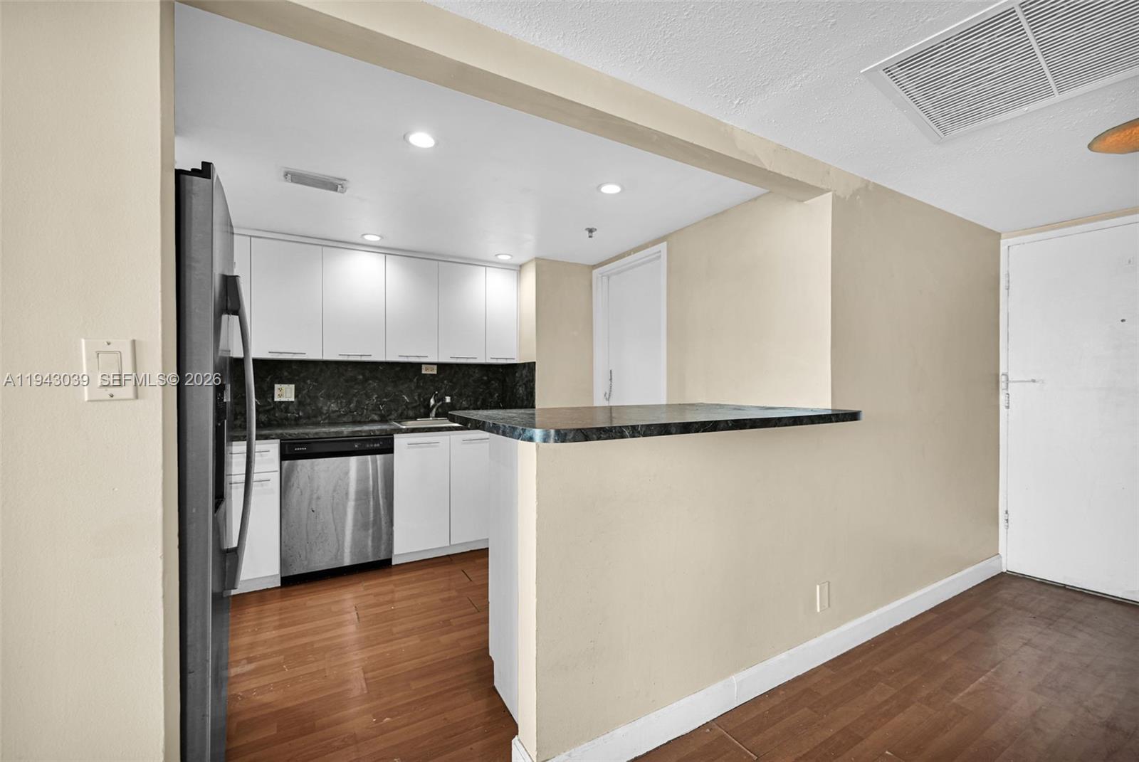 900 Bay Drive, Unit 321 Miami Beach, FL 33141 - Photo 8 of 67 a view of a refrigerator in kitchen and wooden floor