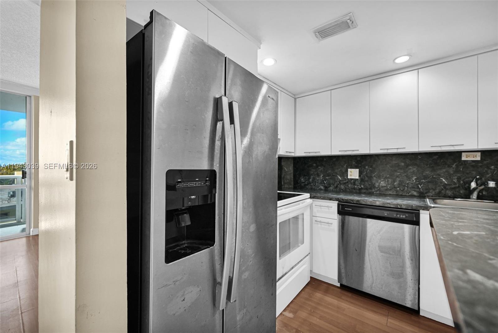 900 Bay Drive, Unit 321 Miami Beach, FL 33141 - Photo 9 of 67 a modern kitchen with stainless steel appliances granite countertop a refrigerator and a stove top oven