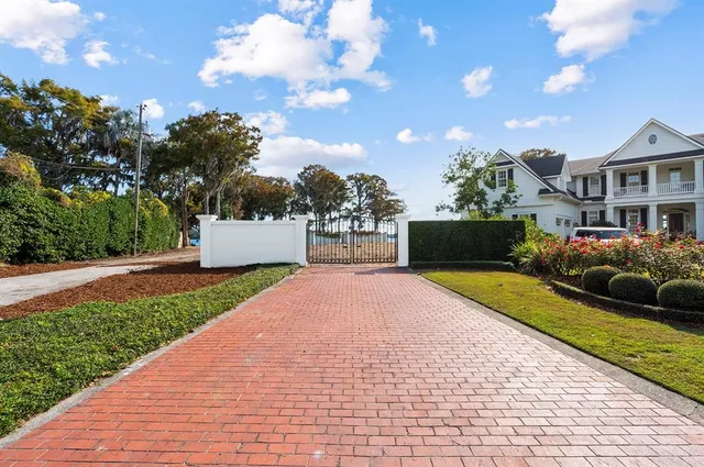 a front view of a house with a yard and a garage