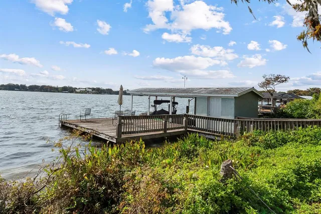 a view of a house with pool and wooden floor