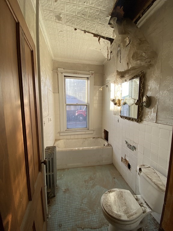 231 Orange Street Springfield, MA 01108 - Photo 4 of 22 a bathroom with a sink a toilet a tub and shower