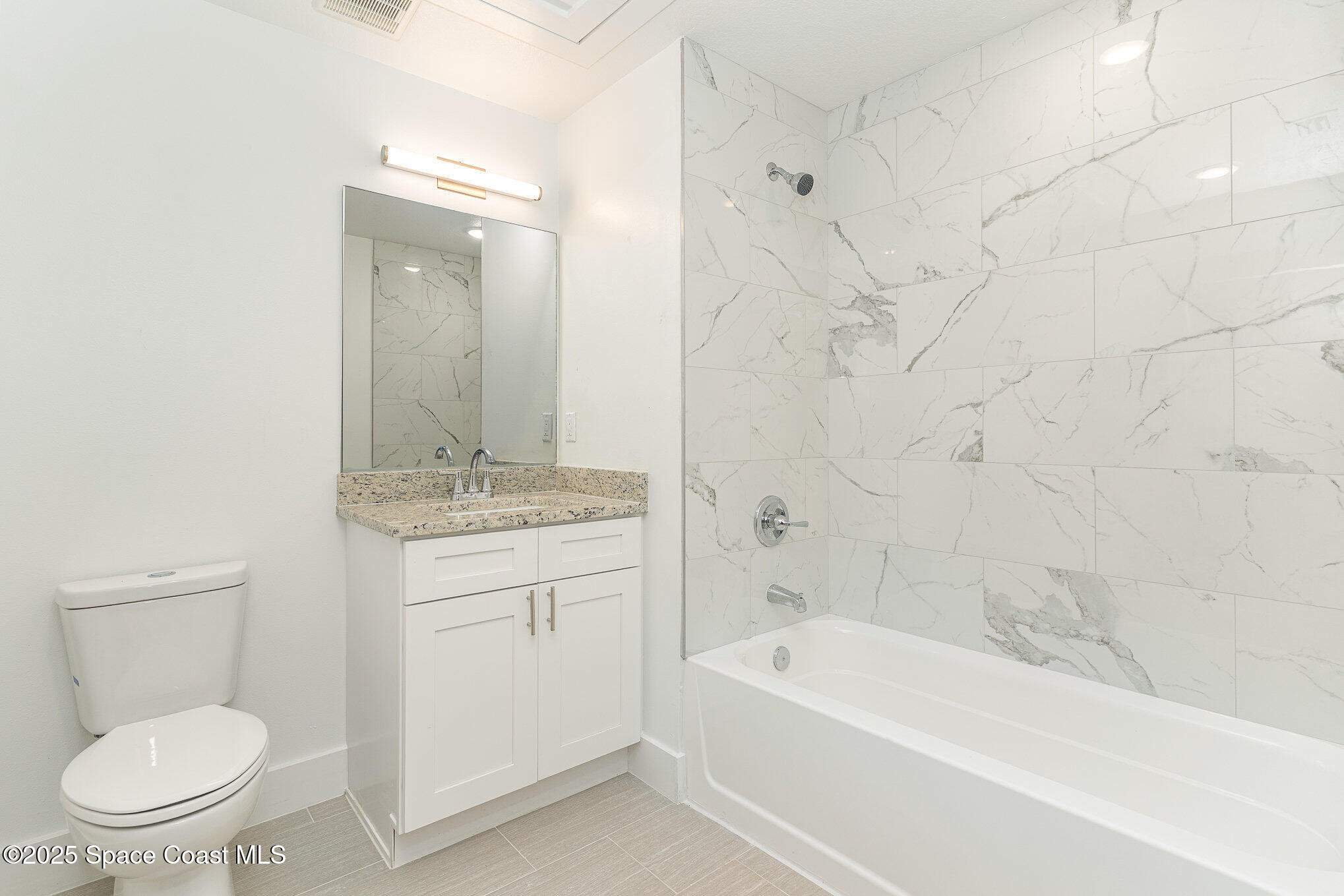 1605 Par Street Northeast, Unit 3202 Palm Bay, FL 32905 - Photo 17 of 42 a bathroom with a sink a toilet and a bathtub