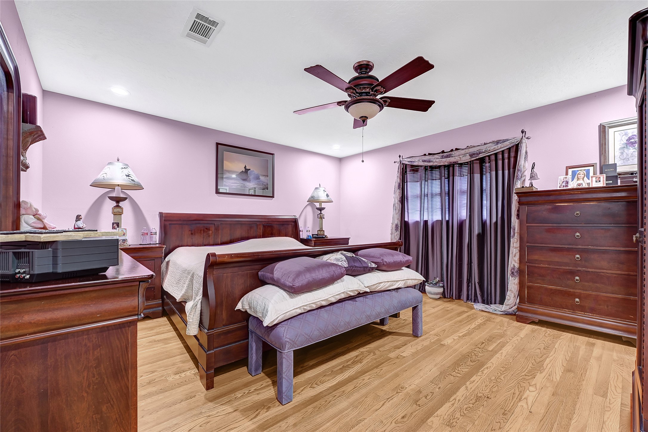 4831 Knickerbocker Street Houston, TX 77035 - Photo 40 of 50 with warm tones, featuring a dark wood bedroom set and ceiling fan.