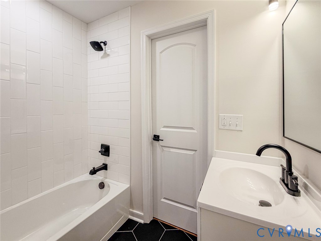 3409 Meadowbridge Road Richmond, VA 23222 - Photo 28 of 32 a bathroom with a sink a bathtub and a shower