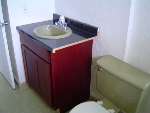 759 Northeast Apollo Palm Bay, FL 32905 - Photo 8 of 12 a bathroom with a sink a toilet and a mirror