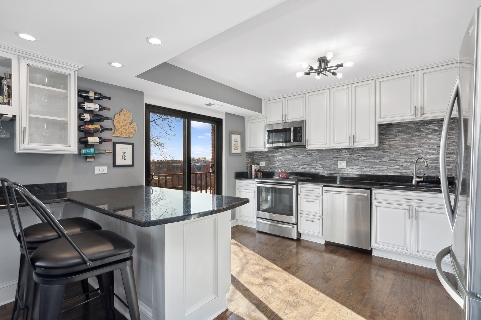 2333 North Geneva Terrace, Unit 6D Chicago, IL 60614 - Photo 5 of 15 a kitchen with granite countertop a stove a sink and a refrigerator