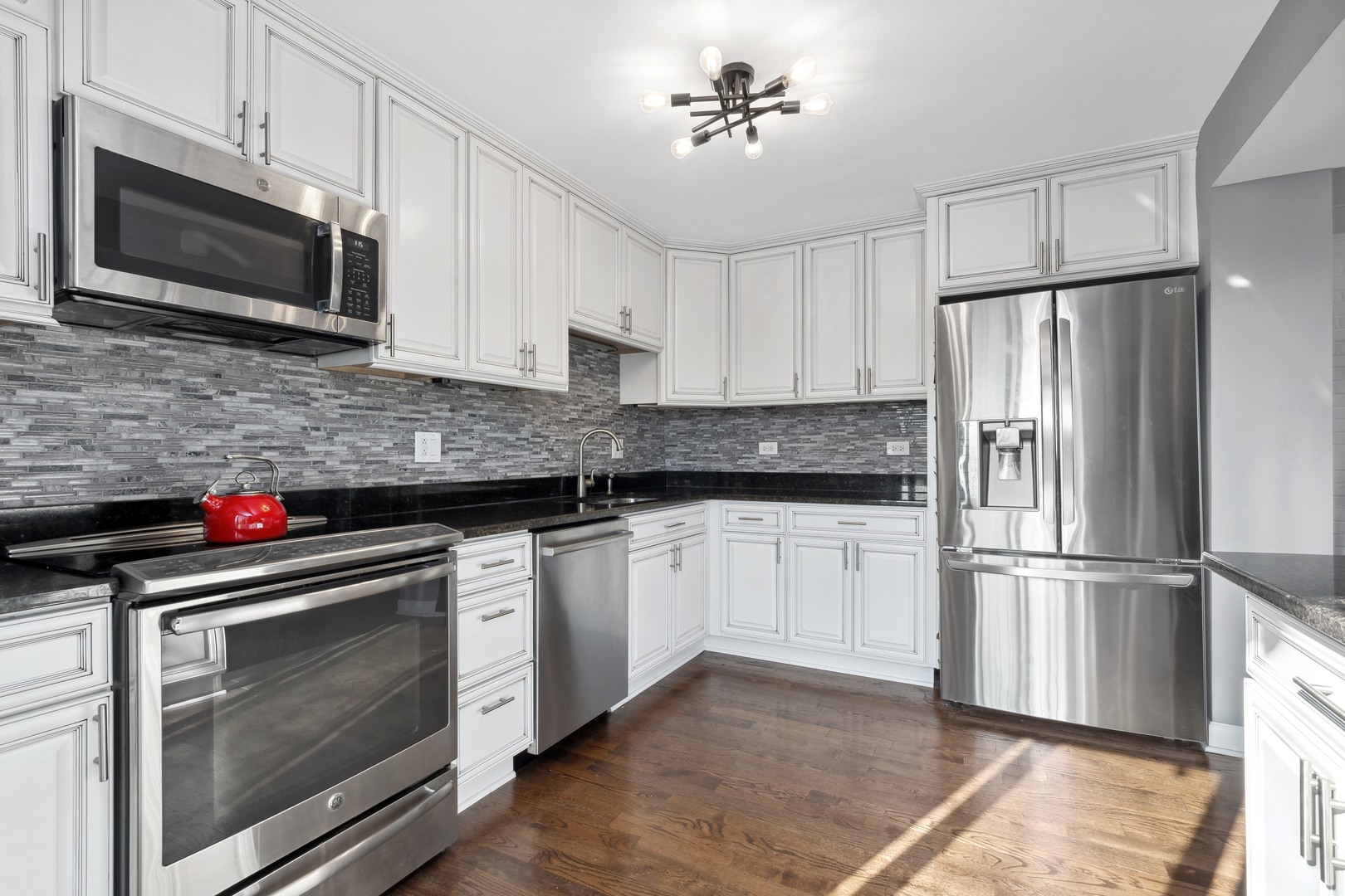 2333 North Geneva Terrace, Unit 6D Chicago, IL 60614 - Photo 6 of 15 a kitchen with stainless steel appliances granite countertop a refrigerator stove a sink dishwasher and microwave