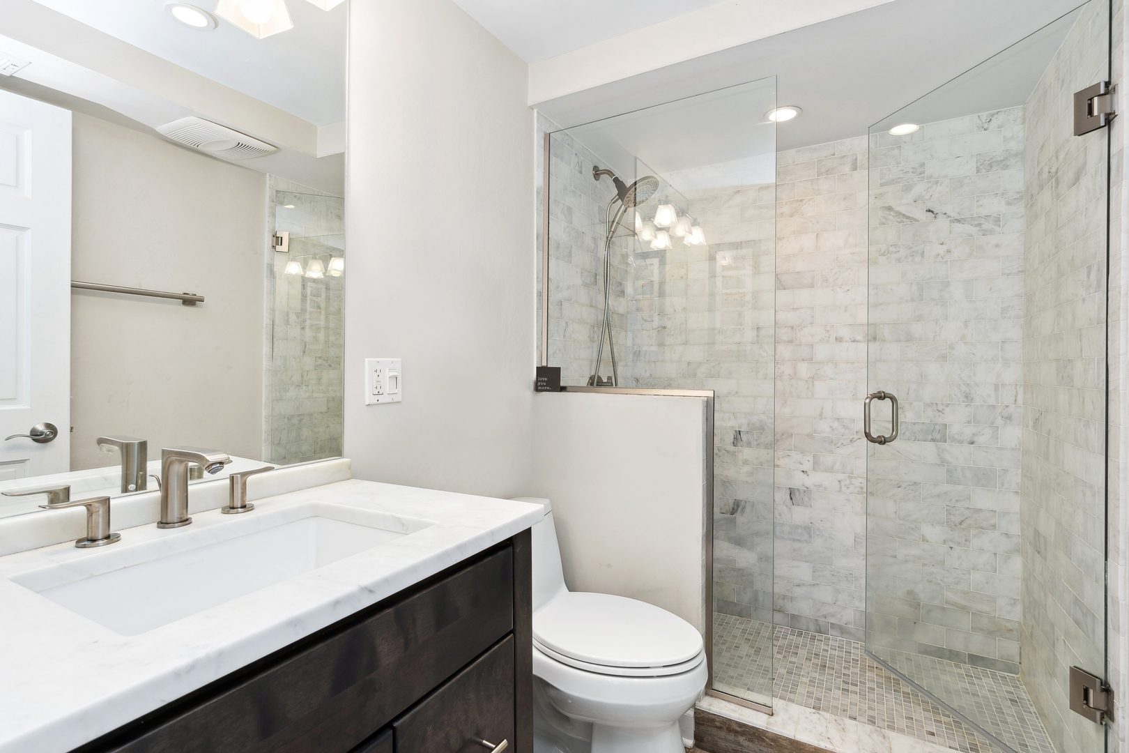 2333 North Geneva Terrace, Unit 6D Chicago, IL 60614 - Photo 10 of 15 a bathroom with a sink a toilet and shower