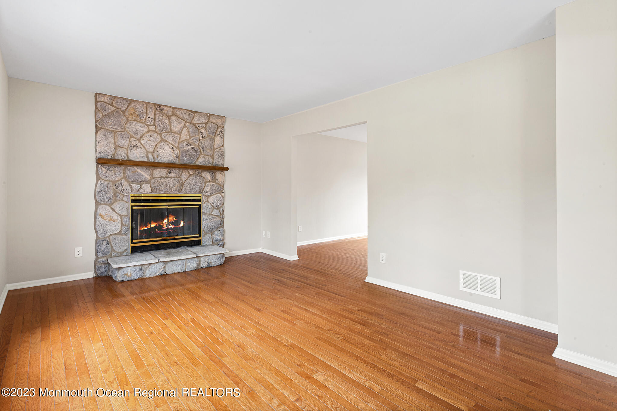 4360 Old Bridge Matawan Road Matawan, NJ 07747 - Photo 22 of 46 a view of an empty room with wooden floor and a fireplace