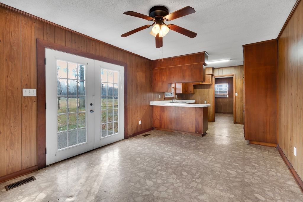 151 Robert Branch Drive Tullahoma, TN 37388 - Photo 13 of 18 a view of a kitchen with a stove cabinets a ceiling fan and wooden floor
