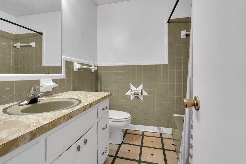 151 Robert Branch Drive Tullahoma, TN 37388 - Photo 18 of 18 a bathroom with a sink a toilet and a mirror