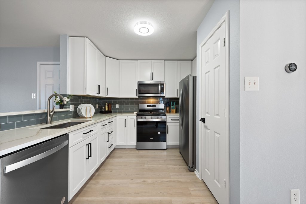 173 Decker Kyle, TX 78640 - Photo 9 of 37 Remodeled Open Concept Kitchen looking into the large spacious living room.