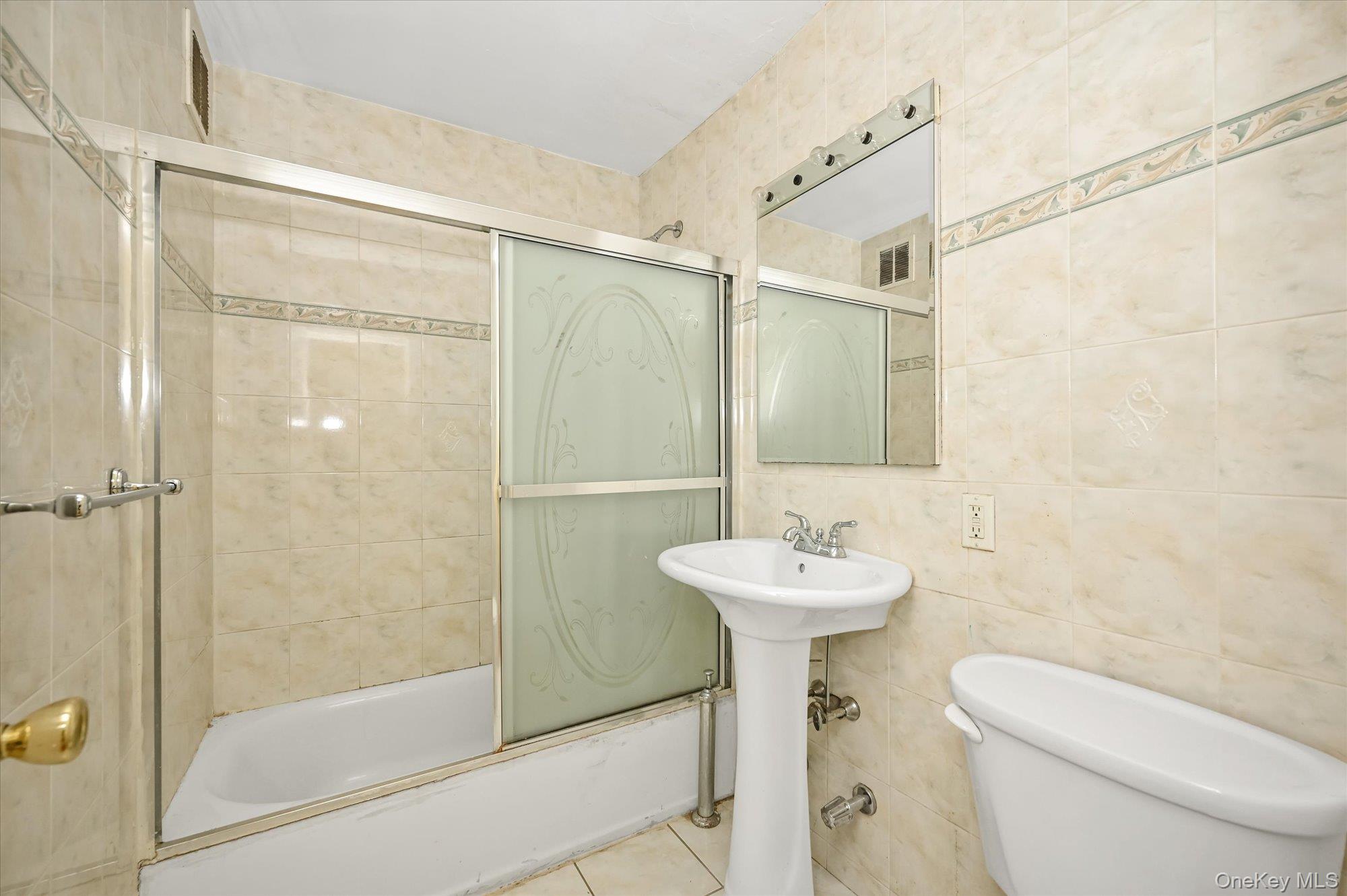 59-30 108th Street, Unit 4P Queens, NY 11368 - Photo 14 of 18 a bathroom with a sink mirror toilet and shower