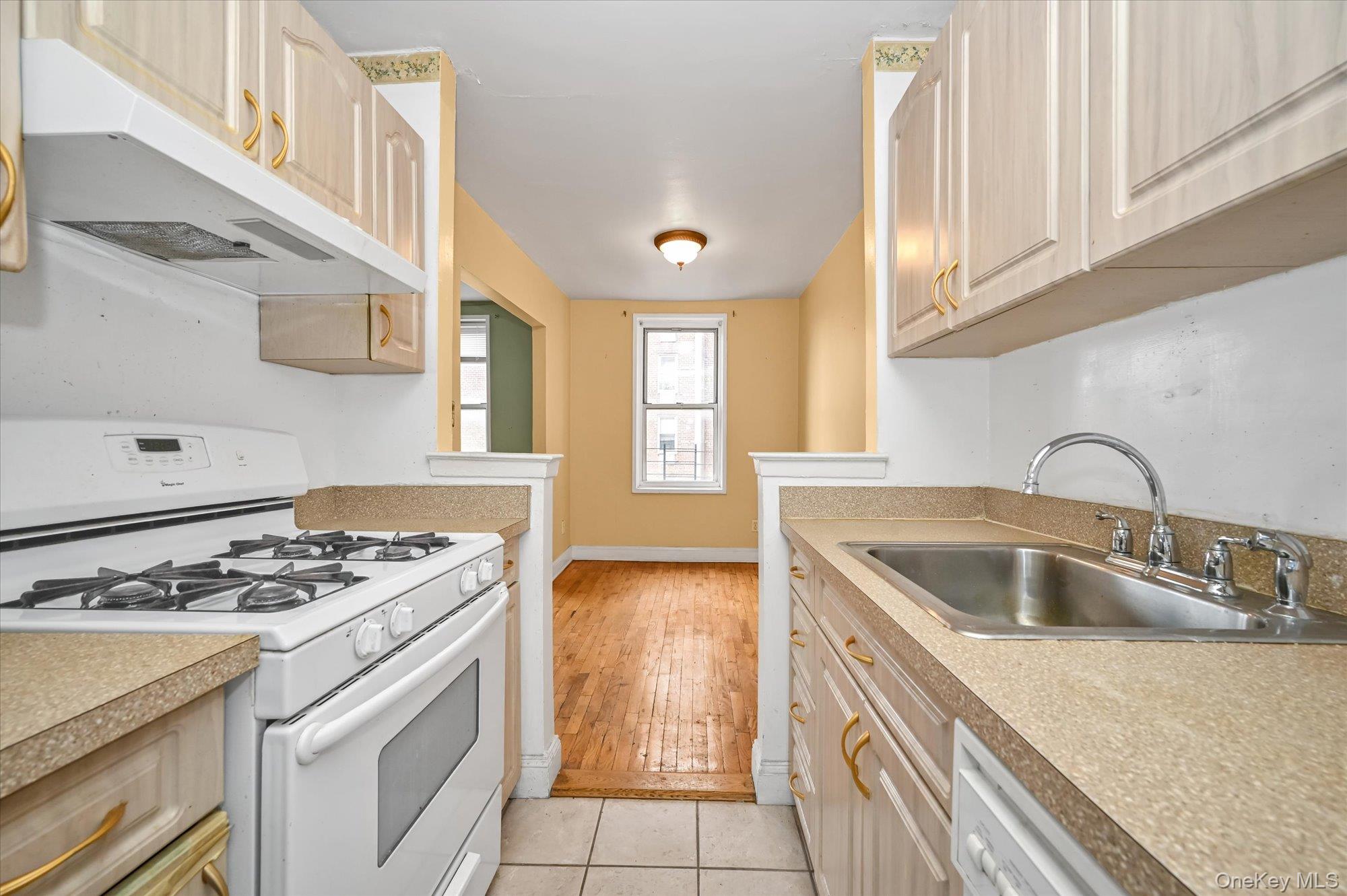 59-30 108th Street, Unit 4P Queens, NY 11368 - Photo 10 of 18 a kitchen that has a sink and a stove