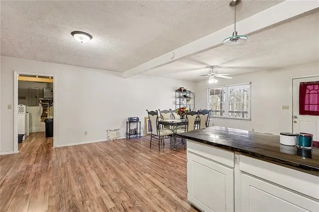 a kitchen with granite countertop a sink cabinets and wooden floor