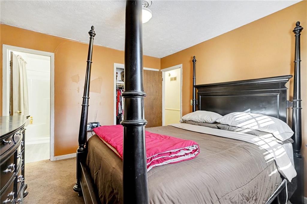 146 Mt Bethel Road McDonough, GA 30252 - Photo 17 of 32 a bedroom with a bed next to a window