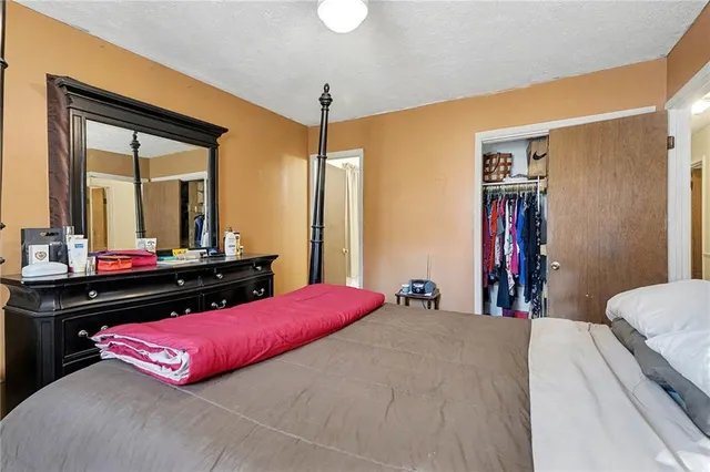 a bedroom with a bed and a dresser