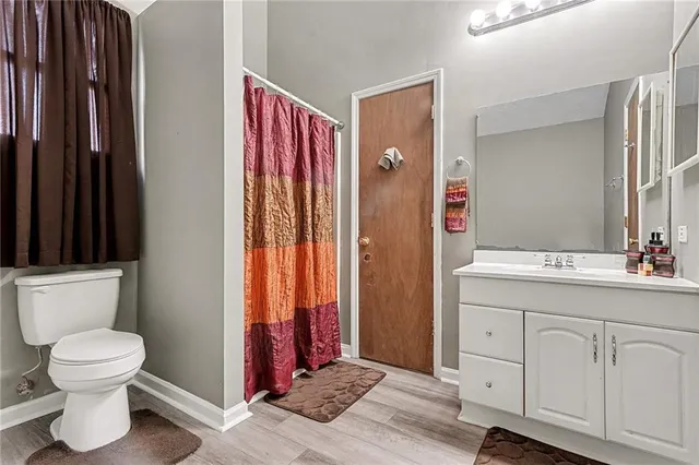 a bathroom with a toilet sink and a mirror