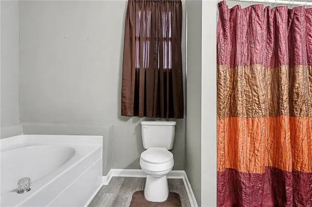 a bathroom with a toilet a sink and bathtub