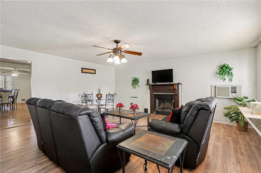 146 Mt Bethel Road McDonough, GA 30252 - Photo 5 of 32 a living room with furniture a fireplace and a flat screen tv
