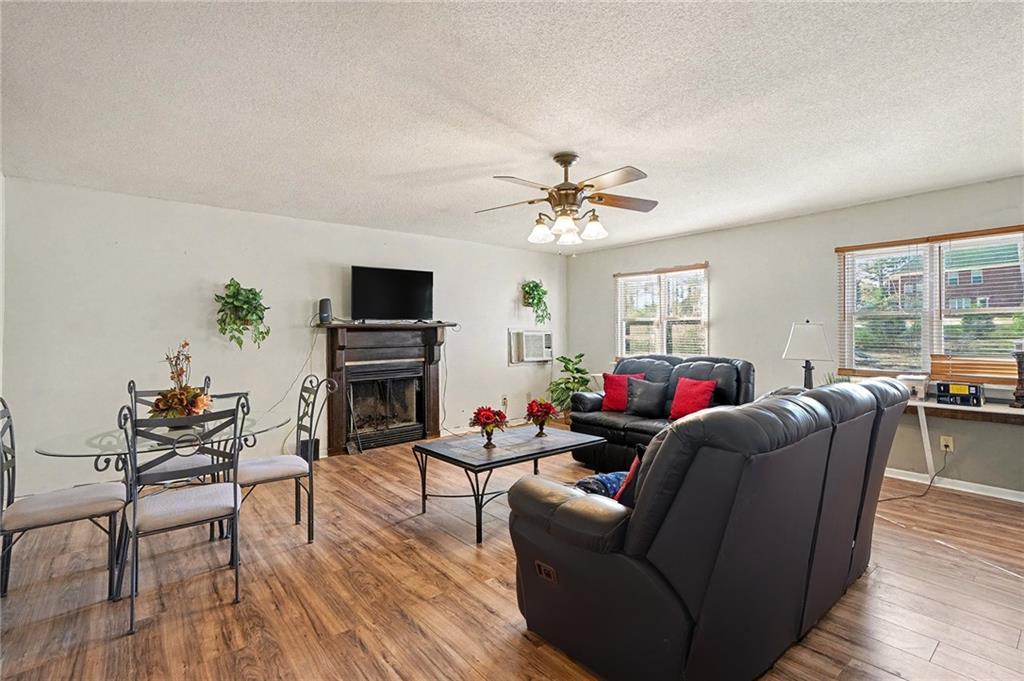 146 Mt Bethel Road McDonough, GA 30252 - Photo 7 of 32 a living room with furniture a flat screen tv and wooden floor