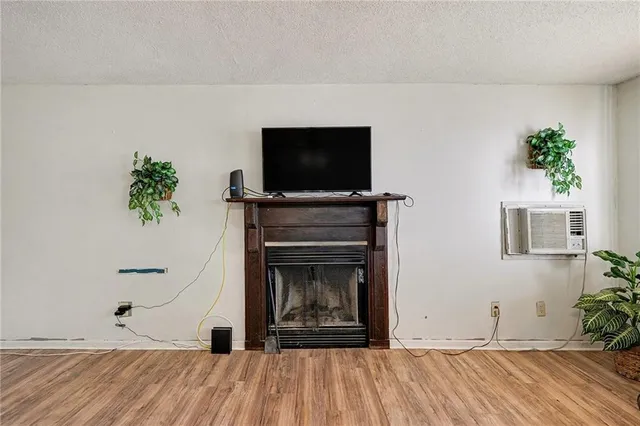 a living room with a fireplace and a flat screen tv