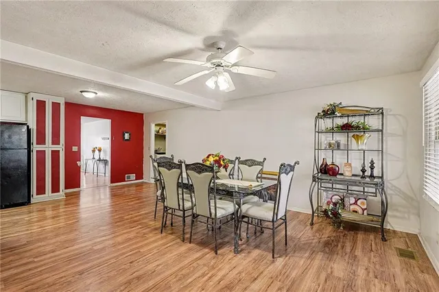 a view of a dining room with furniture and wooden floor